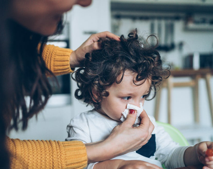 child blowing nose in an article about baby with rsv sleeping a lot