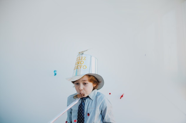 kid in happy new year hat for article on new year's eve instagram captions and quotes