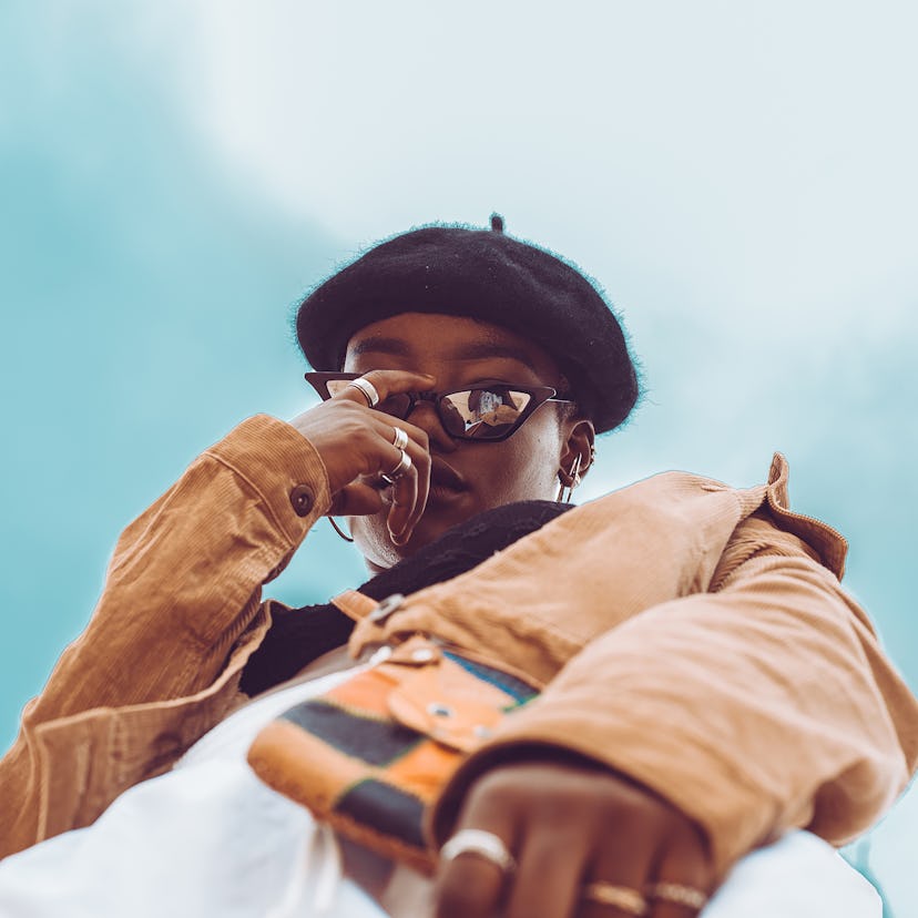a young woman looks down into a camera over her glasses as she considers what the luckiest day in 20...