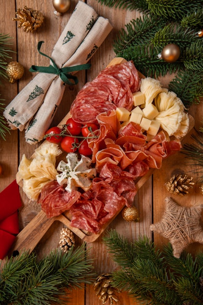 Appetizer Charcuterie Board with ham, salami and cheese for festive Christmas celebration in rustic ...