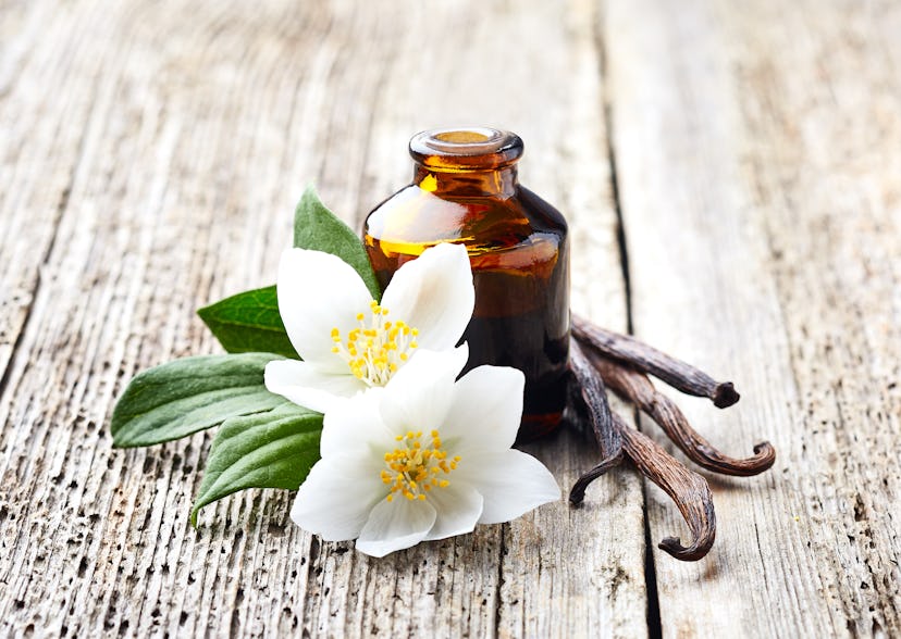 Jasmine and vanilla essential oil on wooden background in an article about most attractive scents