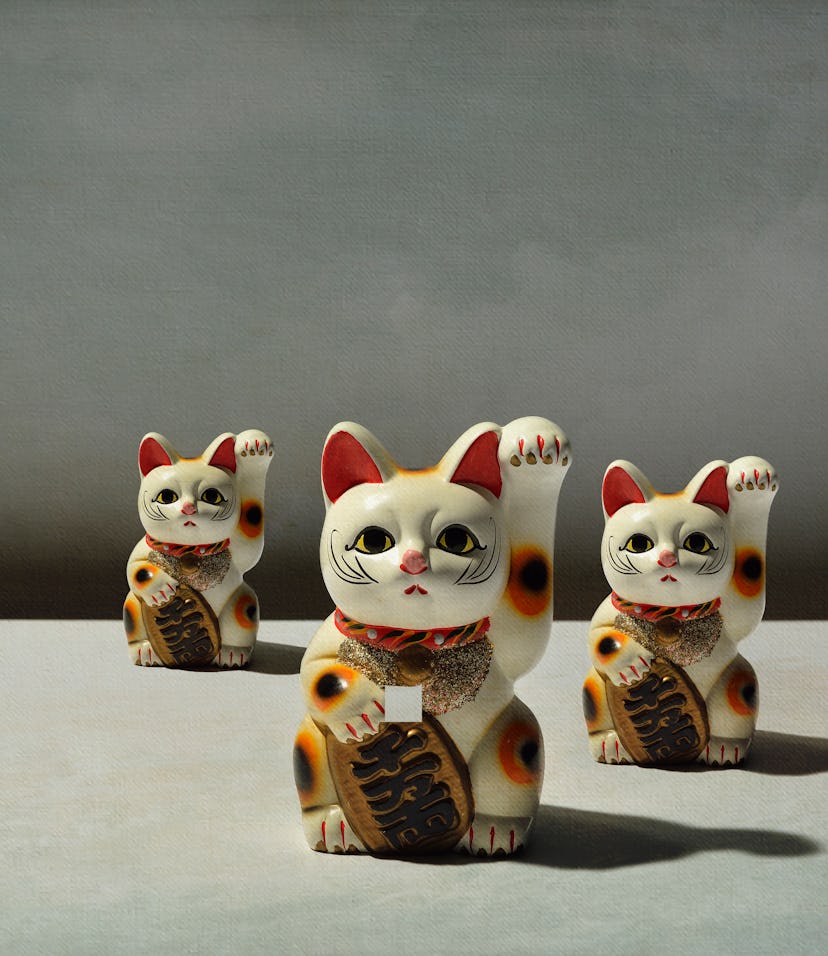 The maneki-neko (literally "beckoning cat") is a common Japanese figurine (lucky charm, talisman) wh...