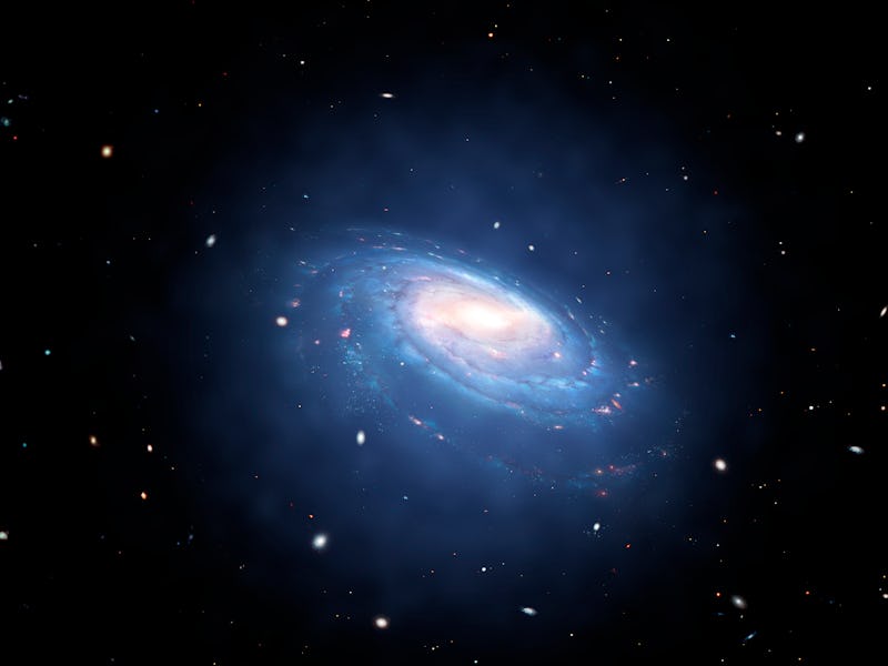 Galaxy and associated dark matter halo, illustration. A dark matter halo is a supposed galaxy compon...