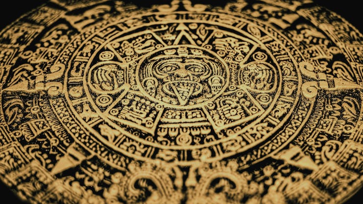 An Aztec or Incan or Mayan gold coin featuring Mayan calendar