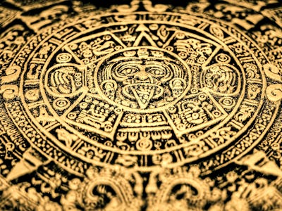 An Aztec or Incan or Mayan gold coin featuring Mayan calendar