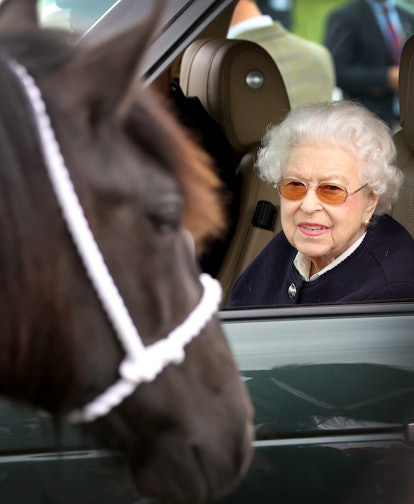WINDSOR, ENGLAND - MAY 13: Queen Elizabeth II watches the horses from her Range Rover at The Royal W...