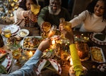 Family toasting on Christmas dinner at home share a photo of their feast on Instagram with Christmas...