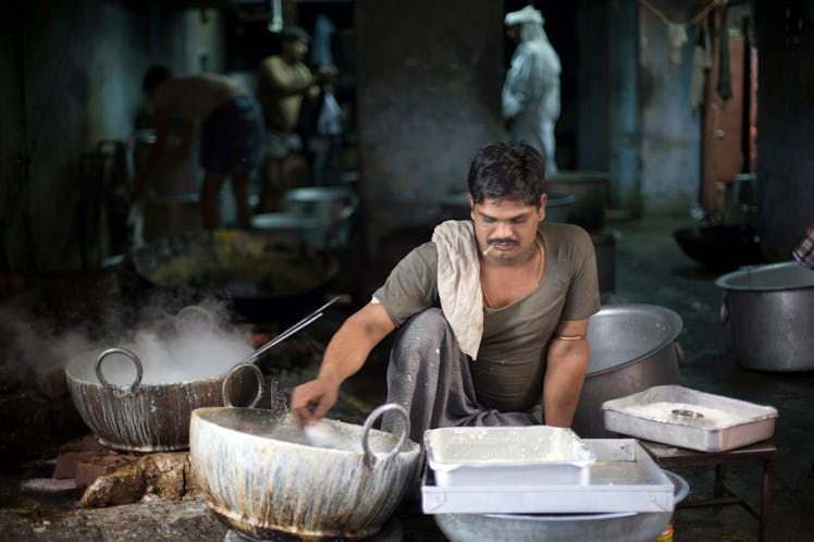 A man making paneer in the backstreets of a Jaipur bazaar, Jaipur, India (Photo by In Pictures Ltd./...