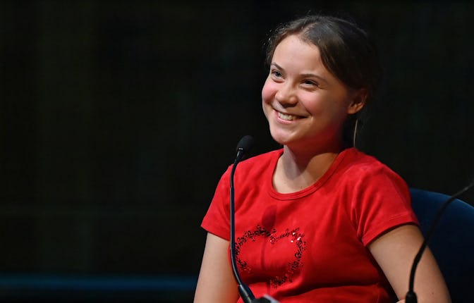 Swedish climate activist Greta Thunberg smiles as she speaks on stage during the launch of her lates...