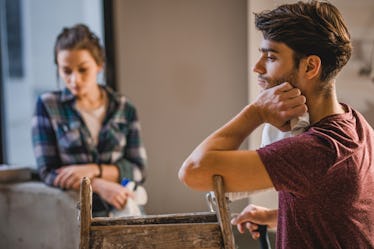 Worried couple thinking of the problems they have for renovating the apartment.