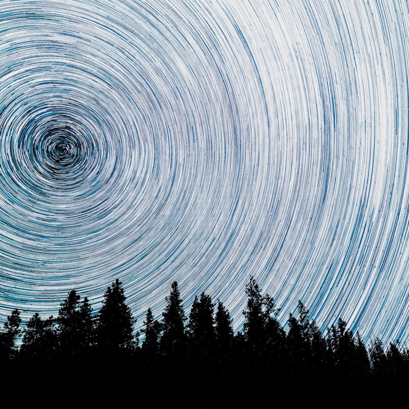 Abundant stars fill the sky on a dark night as meteors from the Perseid Meteor Shower blaze across t...