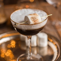 White Russian cocktail drink with Espresso and marshmallow in festive Christmas holiday scene