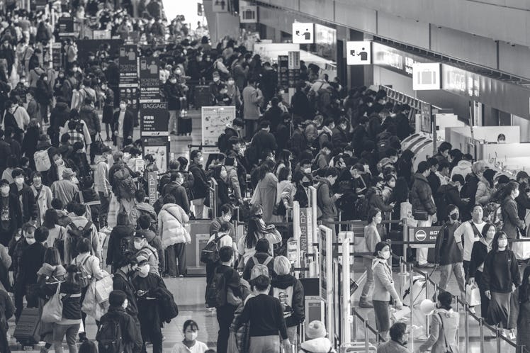 Passengers arrive at Tokyo's Haneda international airport on December 29, 2022, ahead of the New Yea...