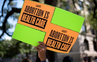 An abortion rights demonstrator holds a sign outside of the Harris County Courthouse during the Wome...