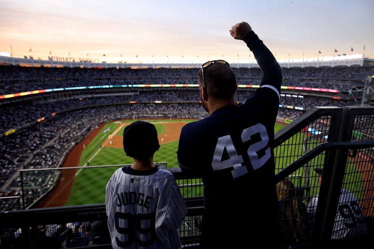 NEW YORK, NY - OCTOBER 22: A father and son are seen cheering during Game 3 of the ALCS between the...