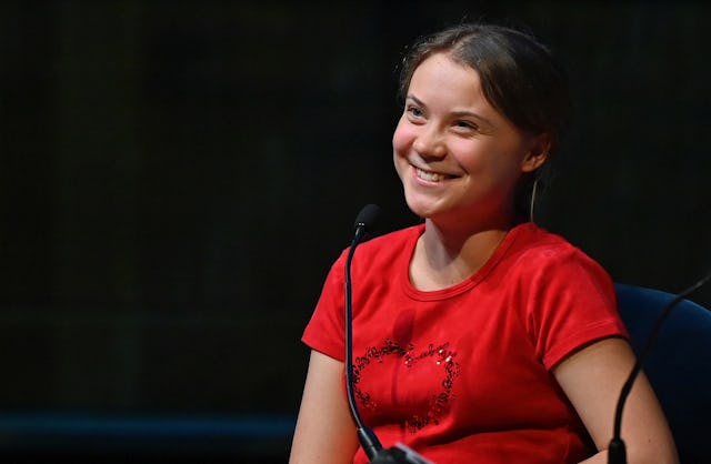 Swedish climate activist Greta Thunberg put Andrew Tate in his place: aka jail. Here, she smiles as ...
