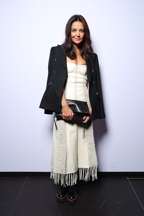 Katie Holmes carrying a black handbag.