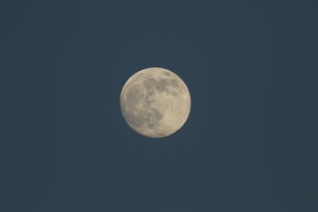 The magnificent Wolf Moon, the first full Moon of January 2022 seen from Kent, UK. An aeroplane can ...
