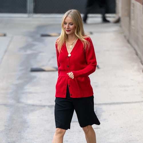 Gwyneth Paltrow wearing a red cardigan sweater.