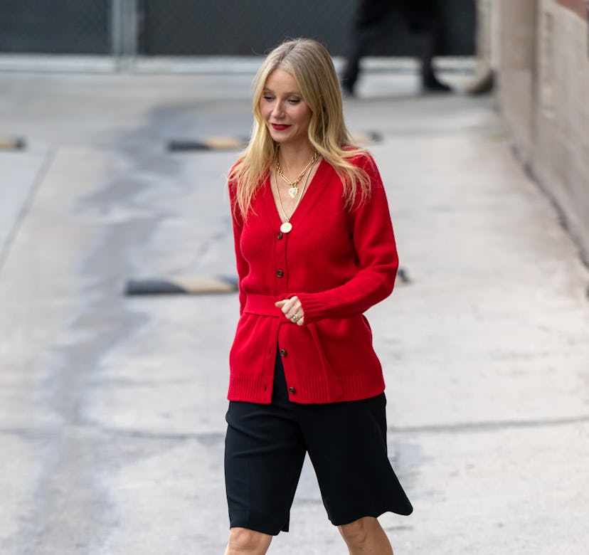 Gwyneth Paltrow wearing a red cardigan sweater.
