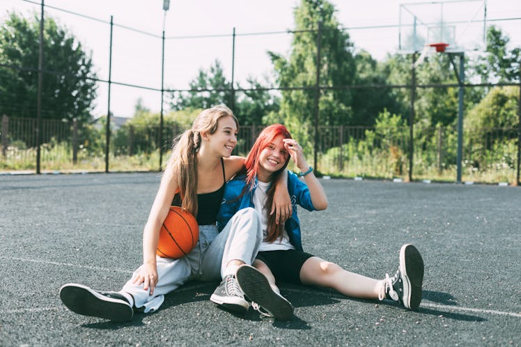 two friends lounge on a basketball court as they discuss how their january 2, 2023 horoscope will im...