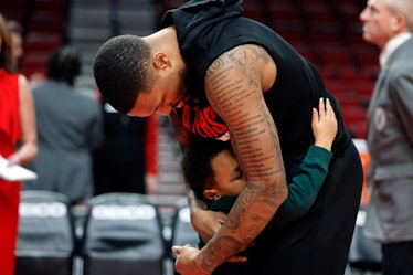 Damian Lillard #0 of the Portland Trail Blazers gets a hug from his son Damian Jr. before the start ...