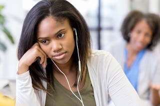 As the unrecognizable mother appeals to her, the teen girl ignores her mother.  The teen is frustrat...