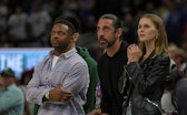 MILWAUKEE, WISCONSIN - APRIL 20:  (L-R) Randall Cobb, Aaron Rodgers and Mallory Edens watch Game Two...