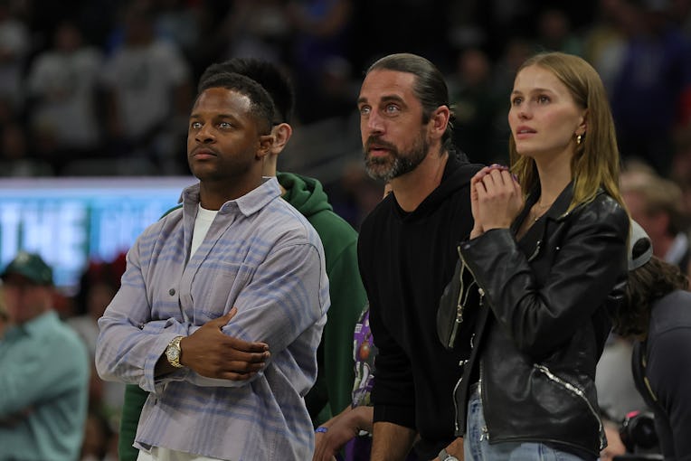 MILWAUKEE, WISCONSIN - APRIL 20: (L-R) Randall Cobb, Aaron Rodgers and Mallory Edens watch Game Two...