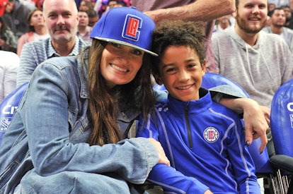 Idina Menzel and Walker Nathaniel Diggs attend a basketball game between the Los Angeles Clippers an...