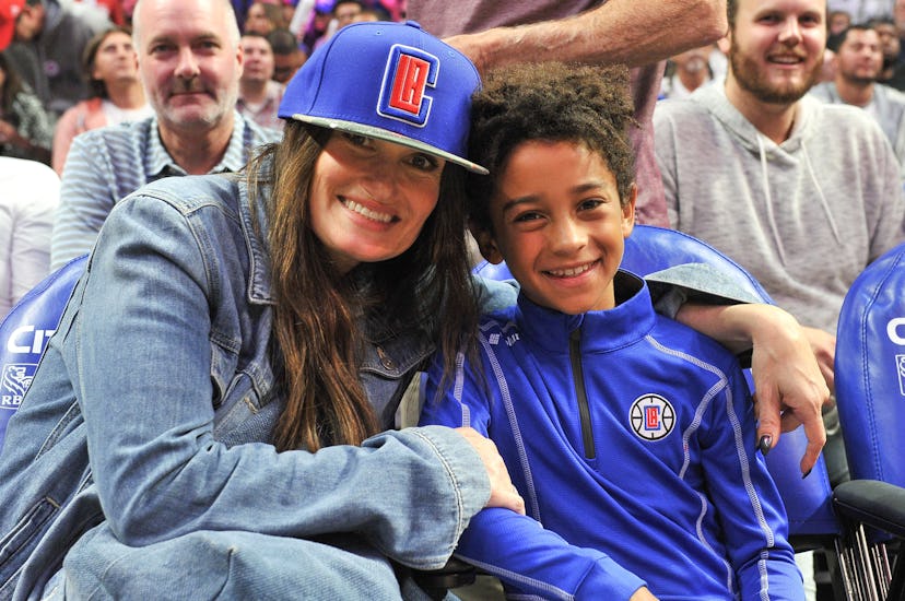 Idina Menzel and Walker Nathaniel Diggs attend a basketball game between the Los Angeles Clippers an...