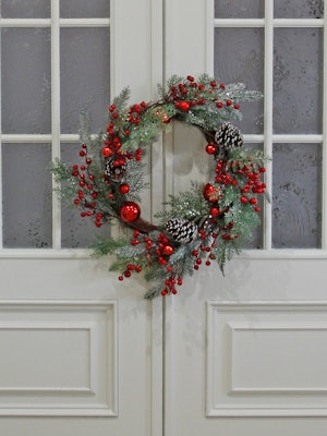 Close-Up Of Christmas Wreath Hanging On Door