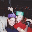 Best friends celebrating at a holiday party. Two friends having fun during the holidays and wearing ...