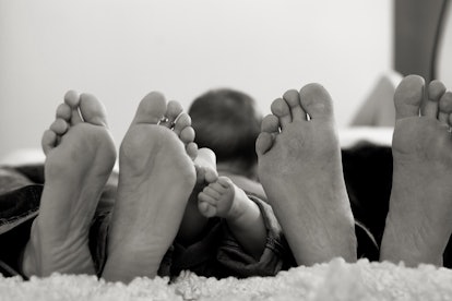 black and white photo of family feet, aries 2023 horoscope 