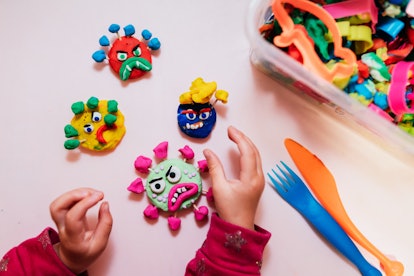 Child playing with play doh in an article about is play doh edible? can you eat play doh?