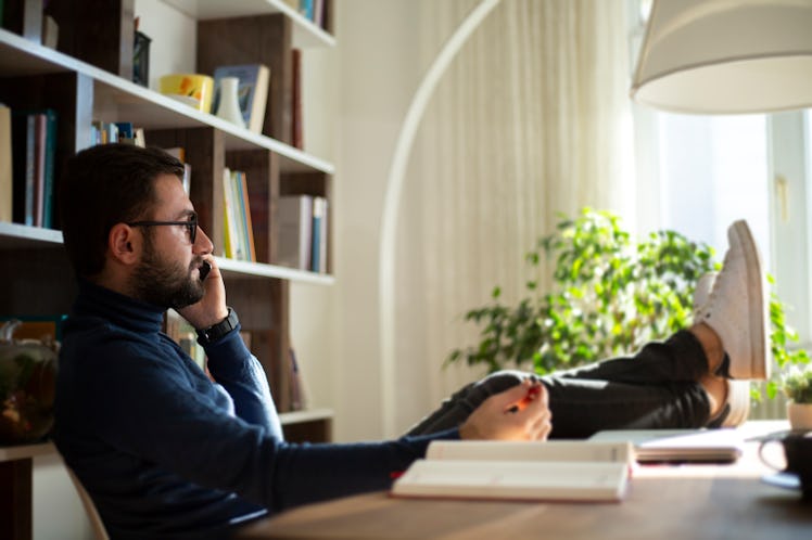 Young man working at home in the evening.