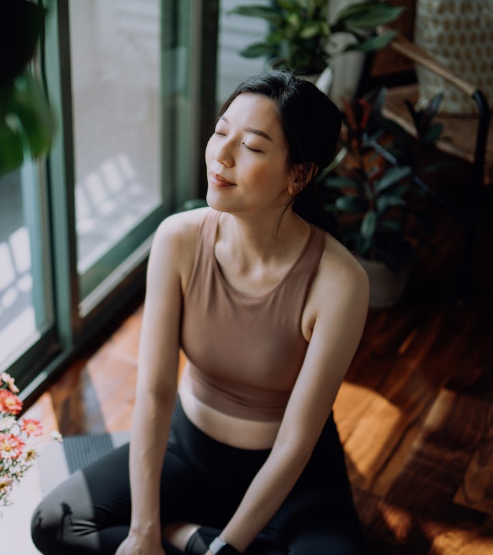 woman doing yoga at home, big exhales are in order for capricorns in 2023