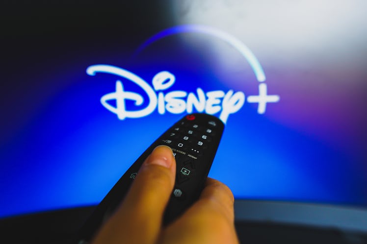 BRAZIL - 2022/05/10: In this photo illustration, a hand holding a TV remote control in front of the ...
