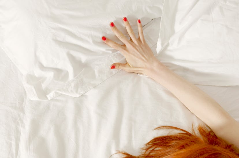 sexy concept shot of painted nails clutching bedsheet, gemini horoscope 2023 says you'll be the ulti...