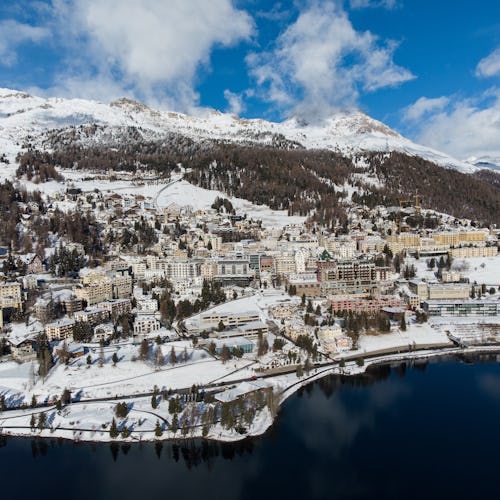 Aerial view of the famous St Moritz village and lake on a sunny winter day in the alps in Canton Gra...