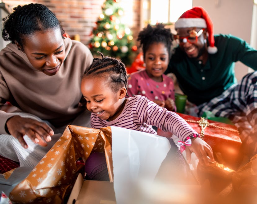 Close up of a young family opening their presents on Christmas morning