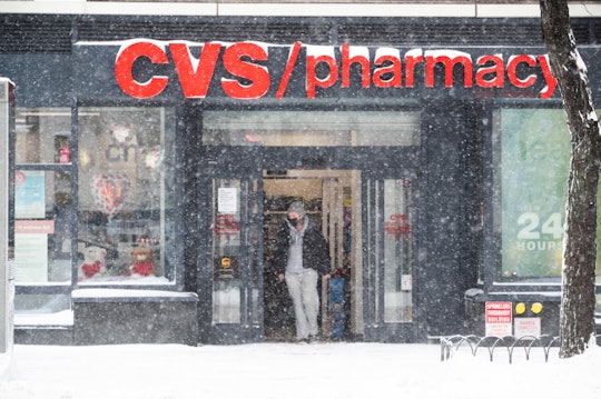 NEW YORK, NEW YORK - JANUARY 29: A person exits CVS Pharmacy during a snow storm in Hell's Kitchen o...