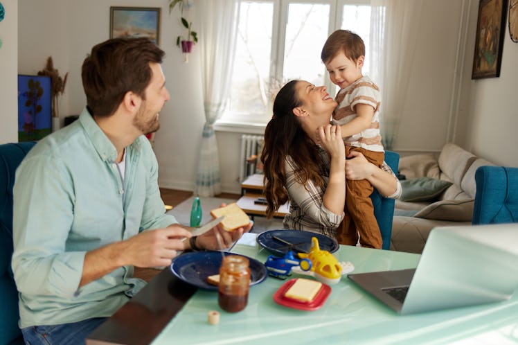 Playful parents spending some quality time with their adorable son at breakfast time