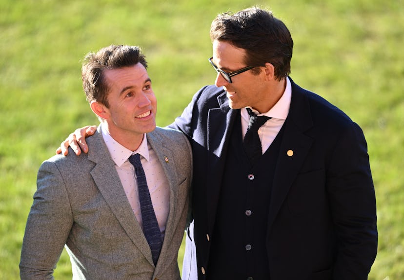 WREXHAM, WALES - DECEMBER 09: Co-Owners Wrexham AFC Rob McElhenney and Ryan Reynolds talk as they wa...