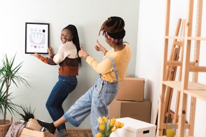 Two women decorate their home using 2023 Gen Z Aesthetics, And Inspiration.