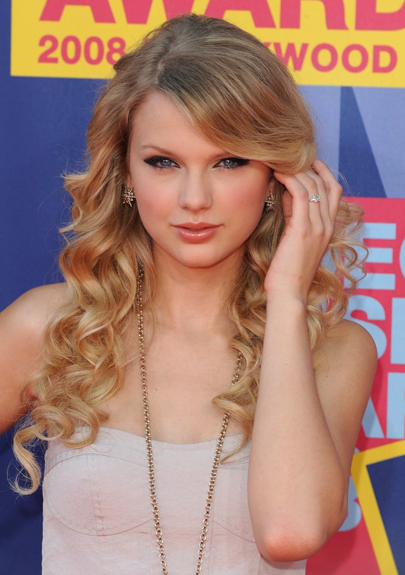 Taylor Swift with curls and side-swept bangs