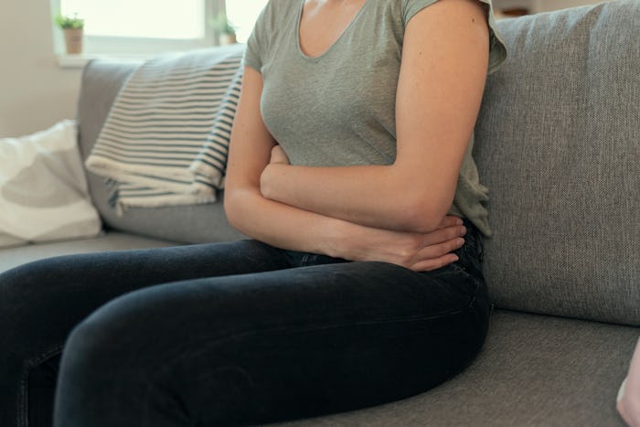 Woman With Abdomen Problems on Couch