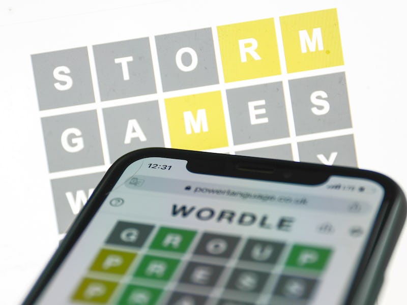 Wordle game displayed on a phone and a laptop screens is seen in this illustration photo taken in Kr...