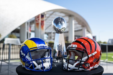 09 February 2022, US, Inglewood: The helmets of the Super Bowl participants Los Angeles Rams (l) and...