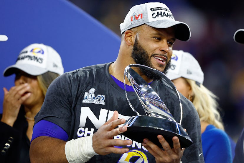 Aaron Donald #99 of the Los Angeles Rams holds the George Halas Trophy after defeating the San Franc...